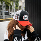 girl wearing matching carl cox trucker hat and track jacket