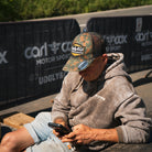 man at race event wearing camo hat
