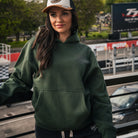 Female model wearing the green Keep It Lit hoodie from the front