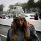 Female model wearing the Uggly&Co Grey Diamond Beanie at the Isle of Man TT