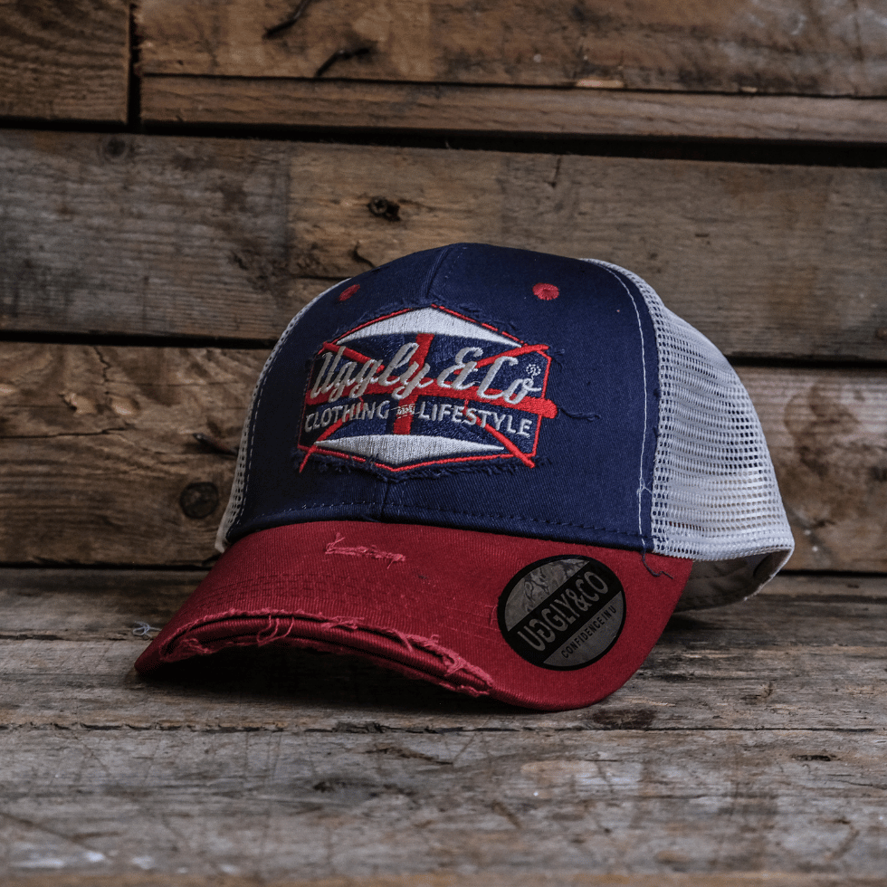 Red and blue cap with a logo on a wooden background