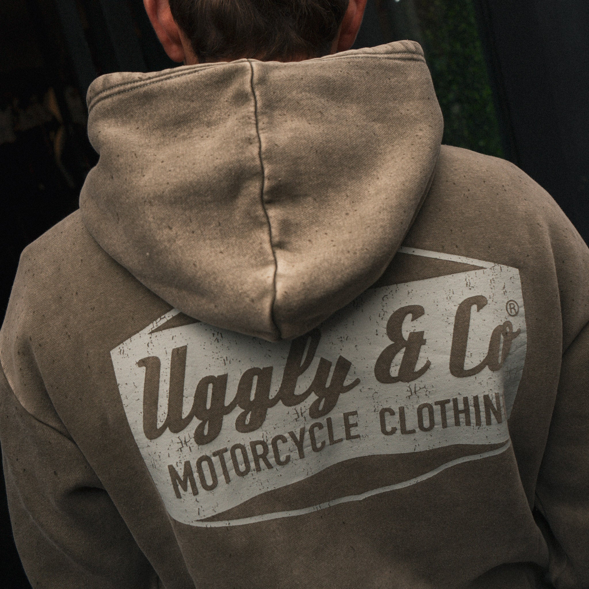Close-up of Joey Thompson wearing the green Diamond acid wash hoodie, showing the hood and washed finish.