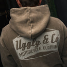 Close-up of Joey Thompson wearing the green Diamond acid wash hoodie, showing the hood and washed finish.