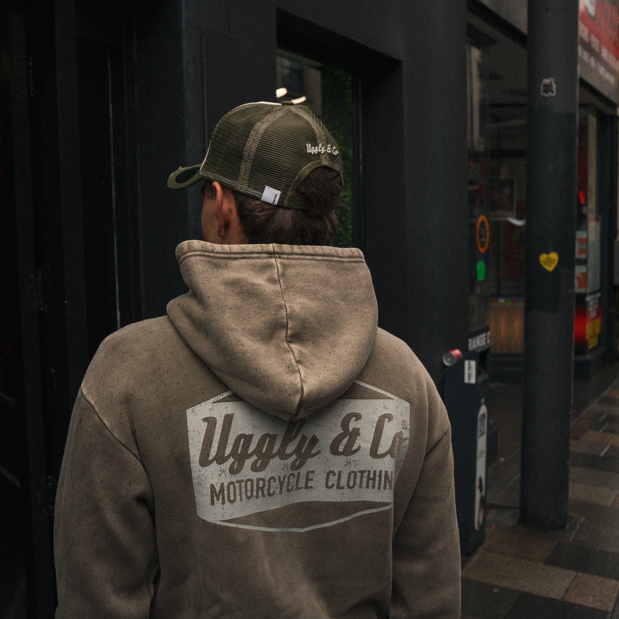 a photo of the back of a green acid wash hoodie worn by tt rider joey Thompson
