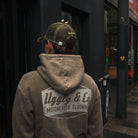 a photo of the back of a green acid wash hoodie worn by tt rider joey Thompson