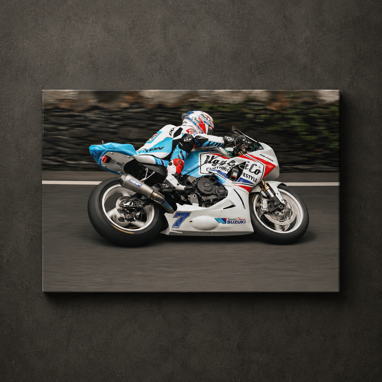 Side view panning shot of Josh Brookes riding the Uggly & Co TT bike during the Isle of Man TT, shown as canvas wall art.