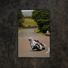 Josh Brookes riding the Uggly & Co TT bike through the Isle of Man course, shown as motorcycle canvas wall art.
