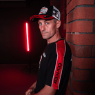 Josh Brookes wearing a Carl Cox motorsport and Team Classic Suzuki black and red t-shirt