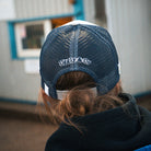 Katie Hand wearing the Uggly&Co Off White and Navy Diamond Trucker Hat