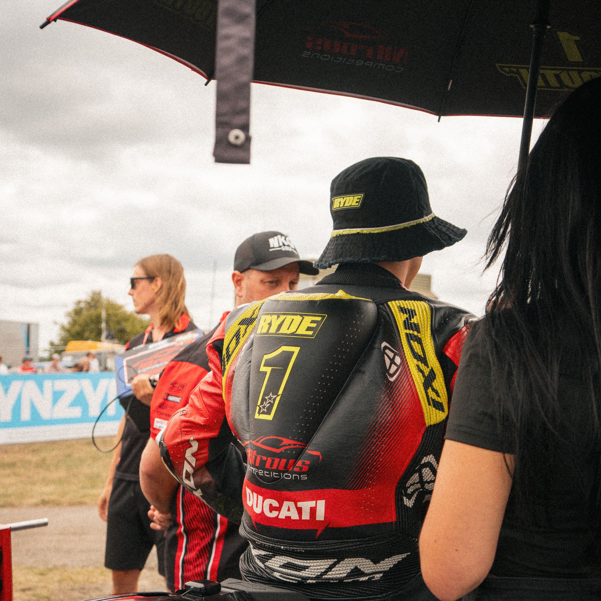 Kyle Ryde on the race grid wearing the black and neon yellow Uggly&Co Diamond Bucket Hat.