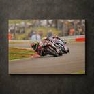 Kyle Ryde leading through a corner during a British Superbike race with another rider close behind, shown as canvas wall art.