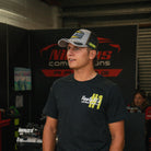 Kyle Ryde Stone Grey Trucker Hat styled in a motorsport lifestyle setting