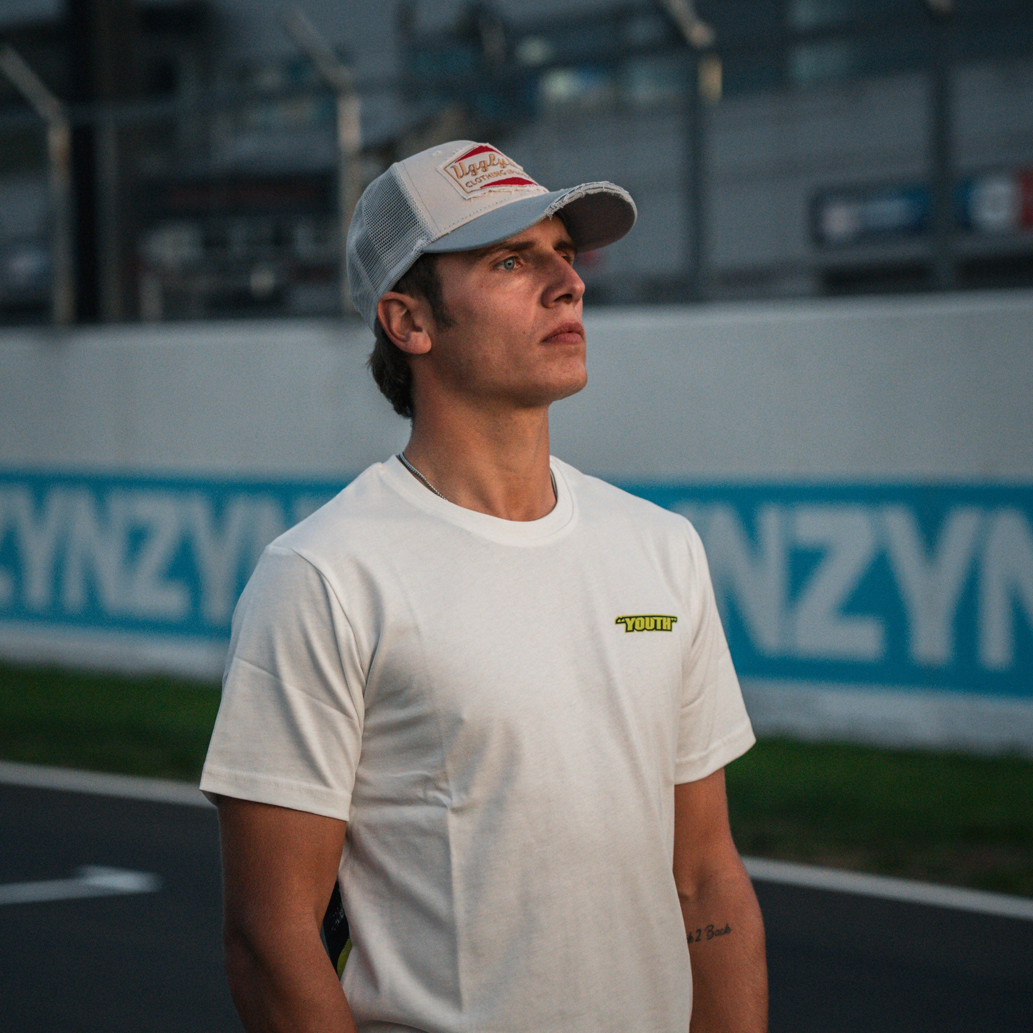 Model wearing the Kyle Ryde White Graphic T-Shirt by Uggly & Co, combining British Superbike racing heritage with casual motorcycle streetwear.