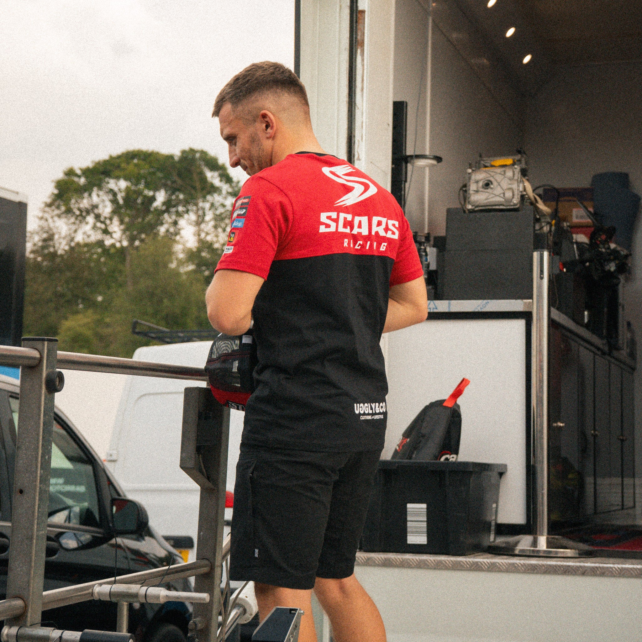 Luke Stapleford wearing the Scars Racing team T-shirt at a motorsport event