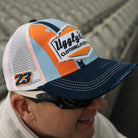 Marcus simpson in racing seats wearing gulf colors cap