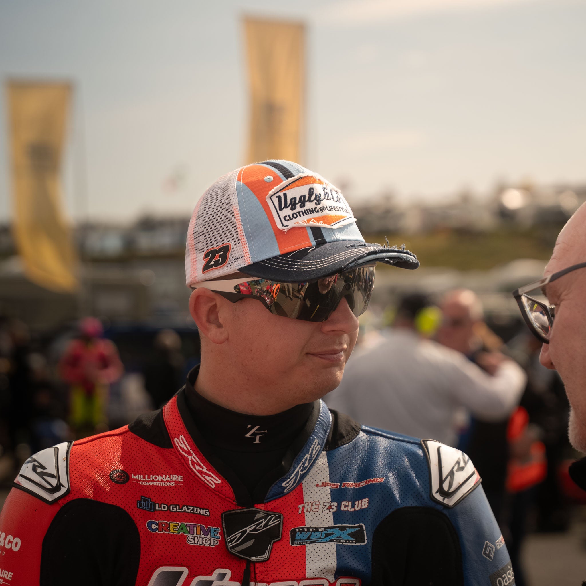 Marcus Simpson signature snapback hat with blue and orange colorway, retro hat seen in pit lane