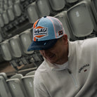 Marcus Simpson wearing signature diamond hat in grandstand 
