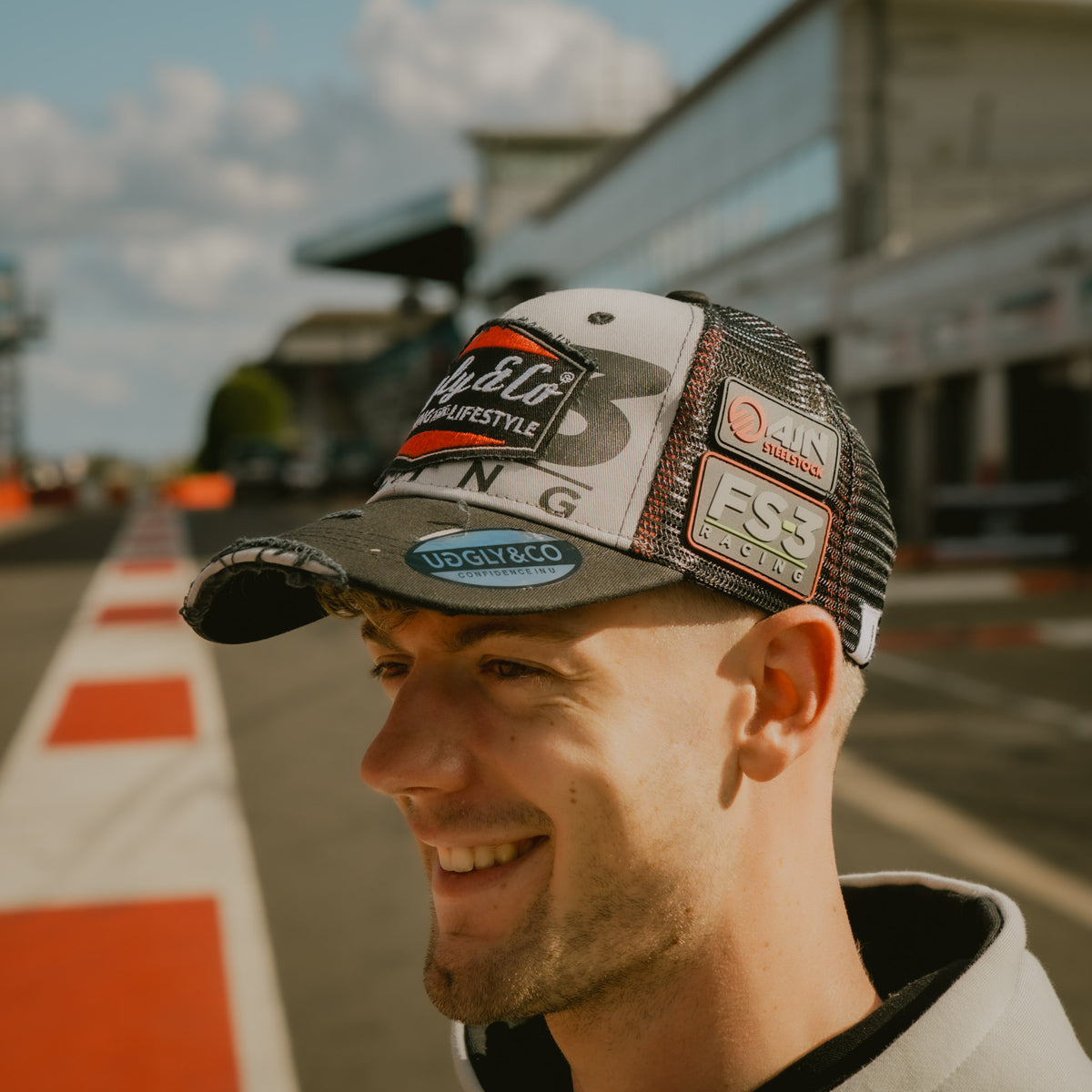 Side view of Max Cook wearing the FS-3 Superbike Racing Trucker Hat in the pit lane