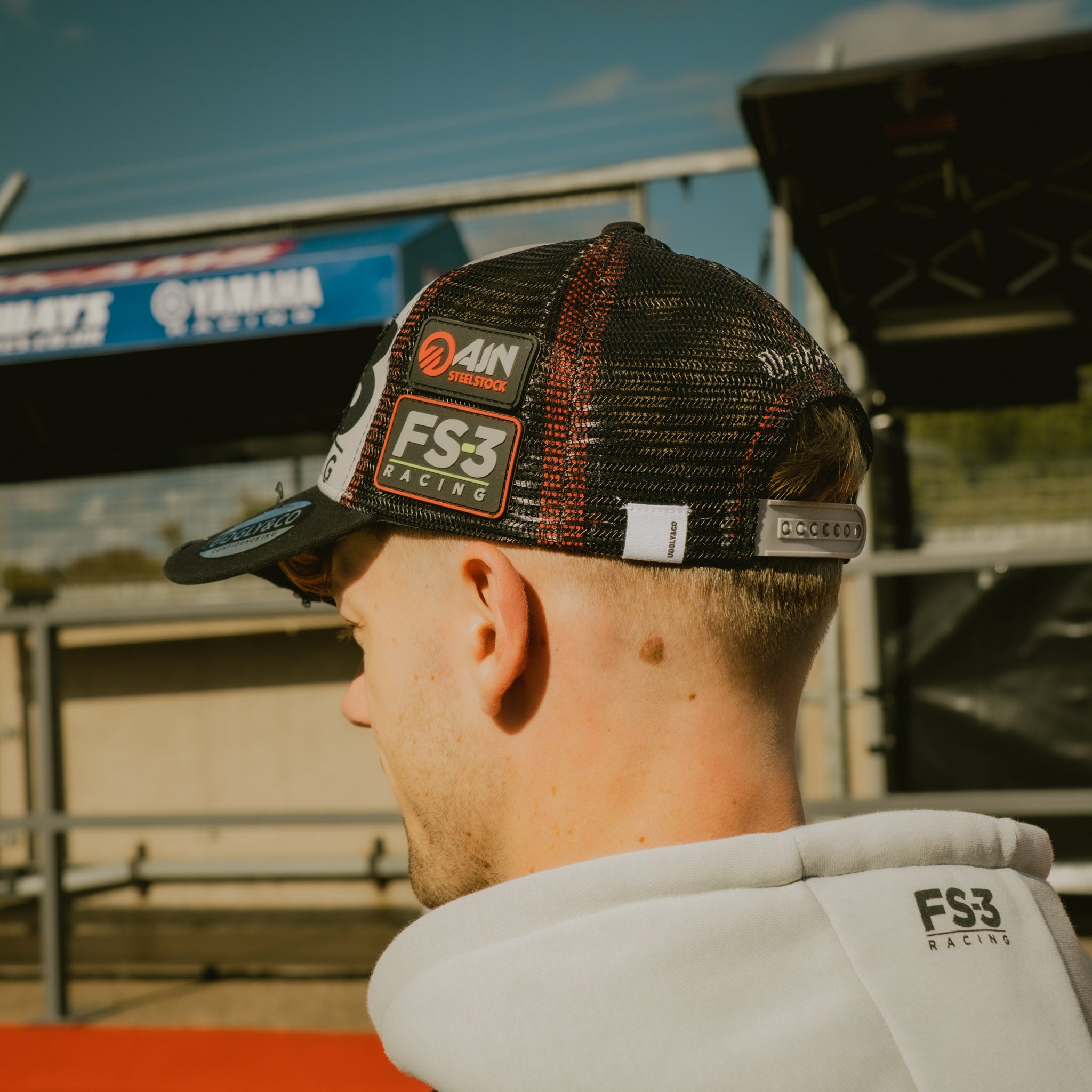 Back view of Max Cook wearing the FS-3 Superbike Racing Trucker Hat in the pit lane
