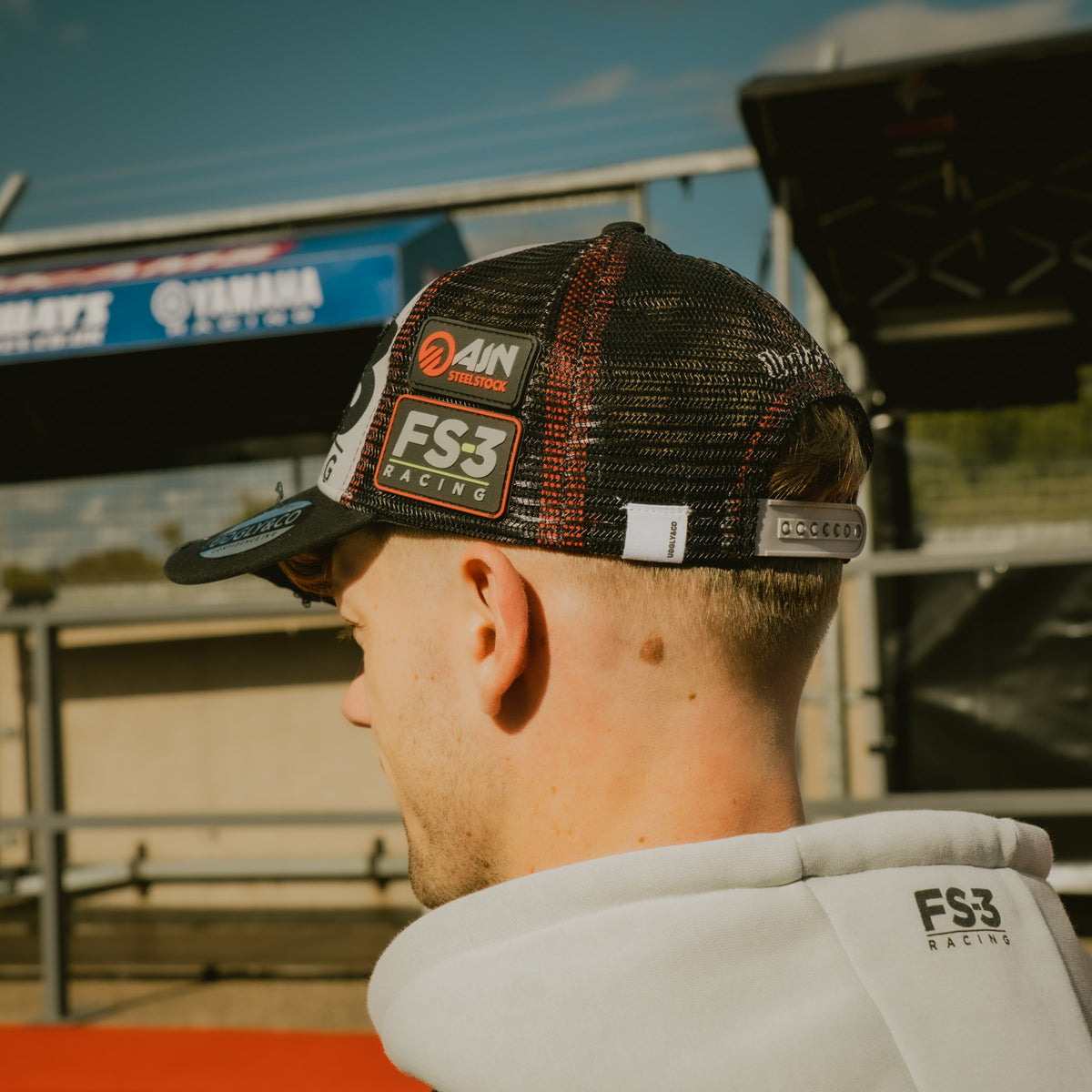 Back view of Max Cook wearing the FS-3 Superbike Racing Trucker Hat in the pit lane