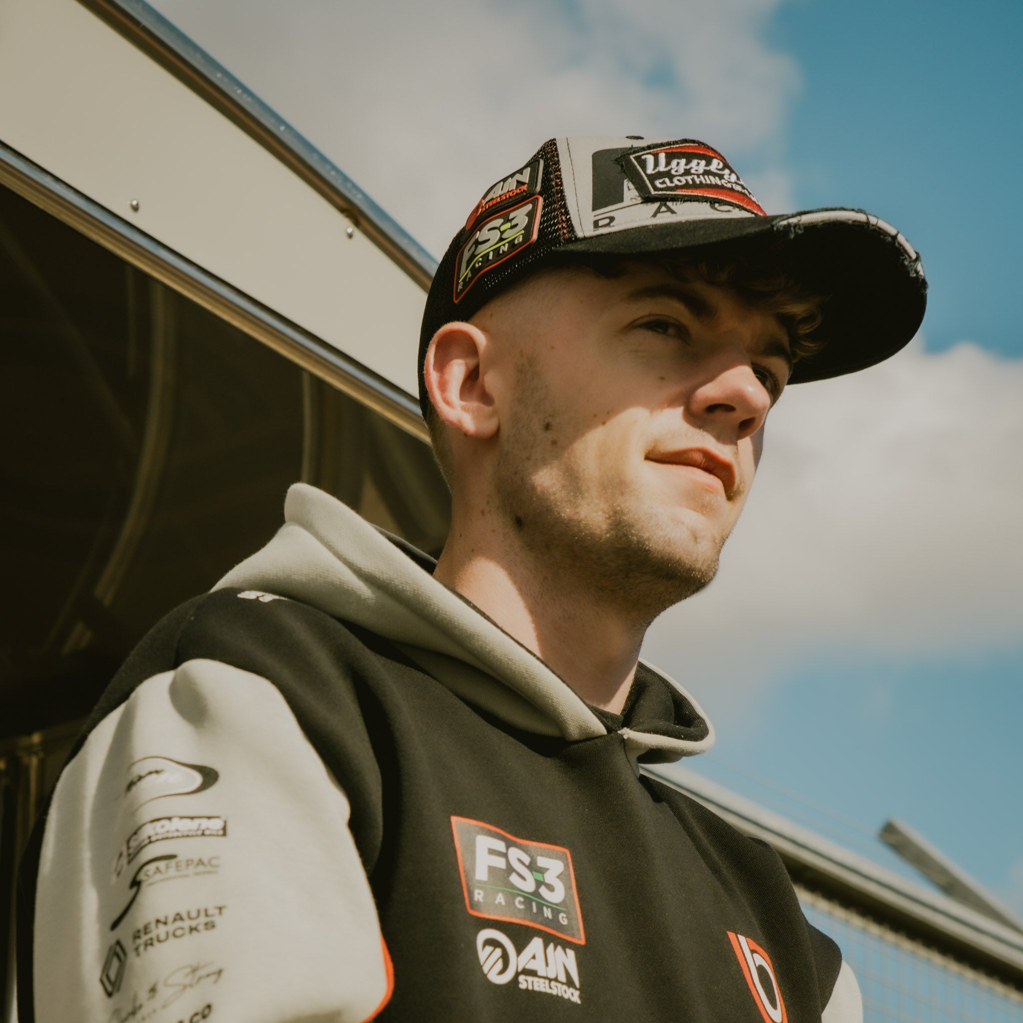 Side view of Max Cook wearing the FS-3 Superbike Racing Trucker Hat in the pit lane