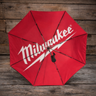 Inside view of a red and black Milwaukee x Ducati umbrella with Milwaukee logo on a wooden background