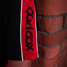 Close up of the sleeve detailon a Carl Cox motorsport and Team Classic Suzuki black and red t-shirt