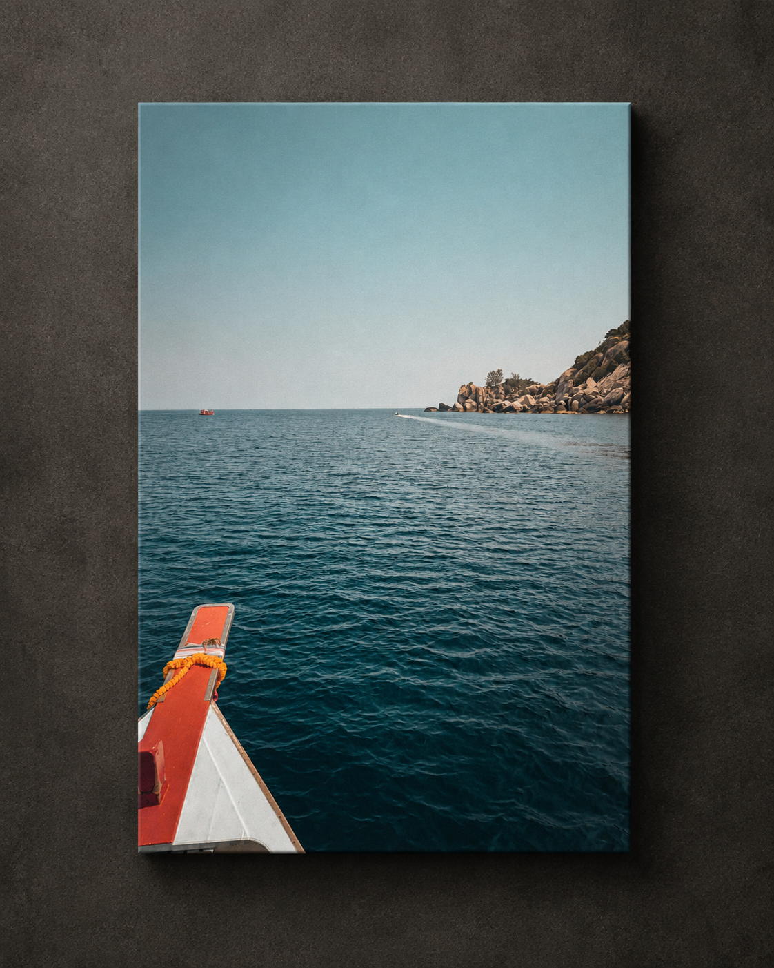 View from a traditional longtail boat crossing calm tropical water towards a rocky coastline, shown as coastal canvas wall art.
