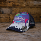 Josh Brooks x 80s Vintage Motocross Diamond Cap with purple, white and checkered racing design on a rustic wooden background.