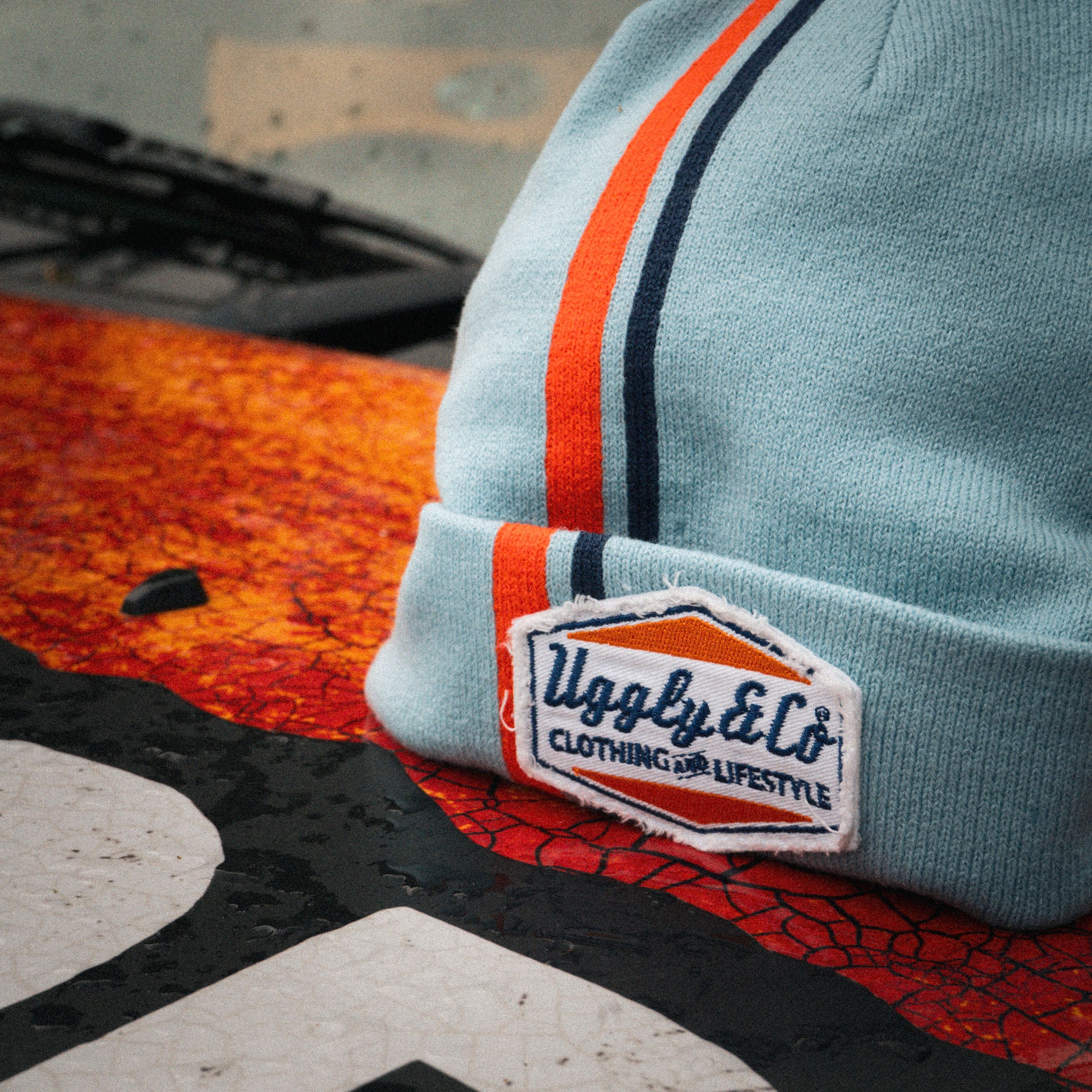 close up shot of the retro diamond light blue and orange beanie