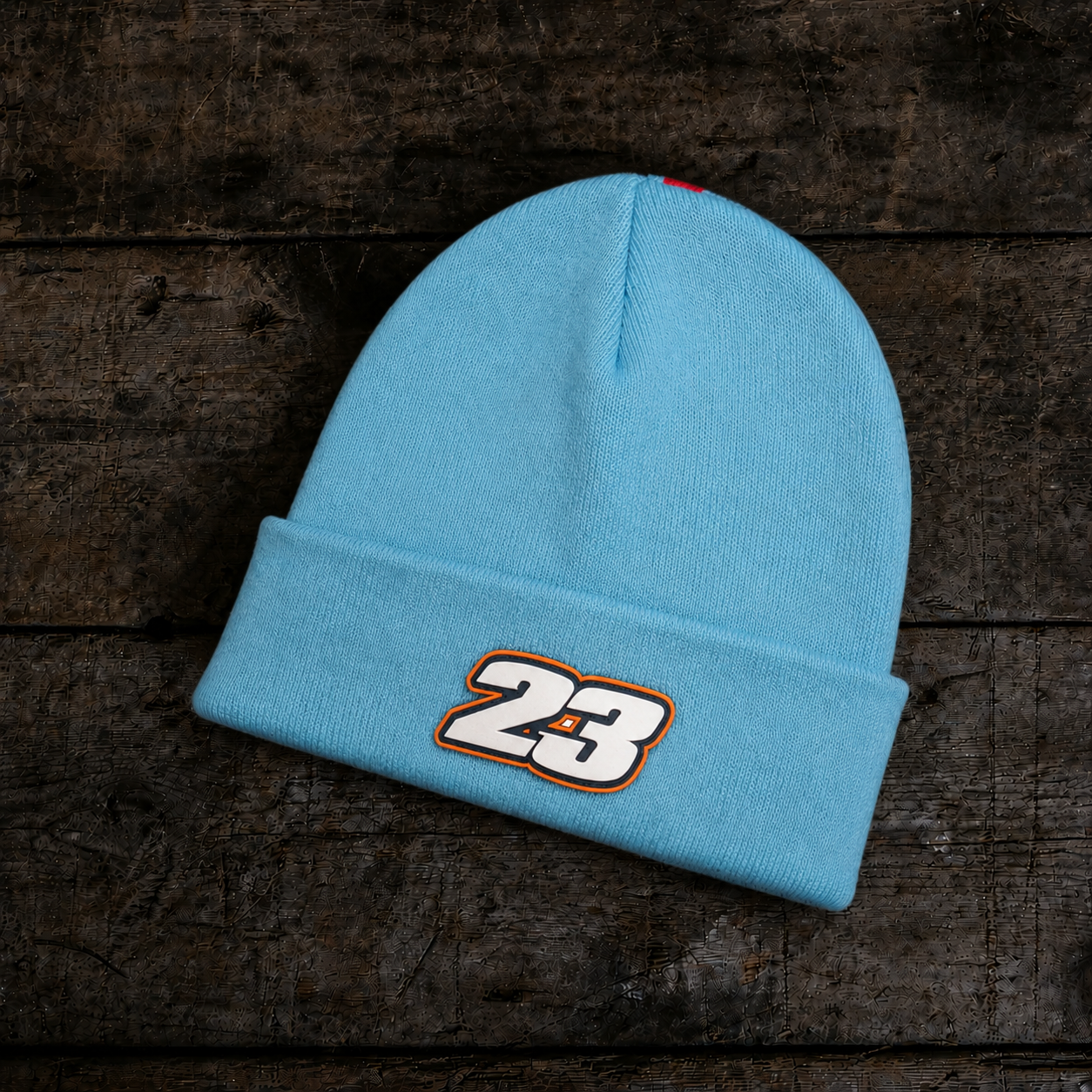 Back product photo of the Retro Diamond Light Blue & Orange Beanie on a wooden background