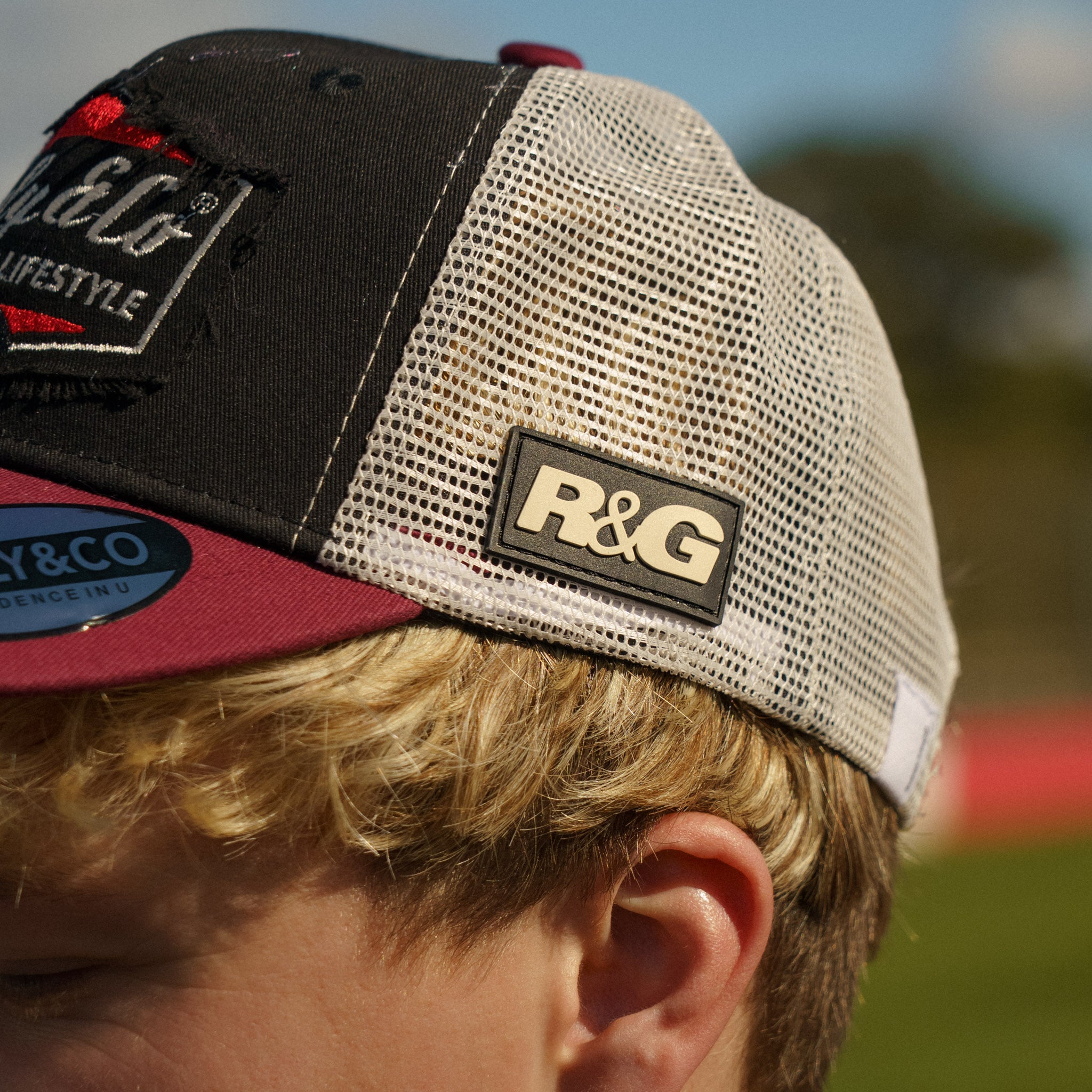 Close-up of the side logo on the R&G Crash Protection Trucker Cap