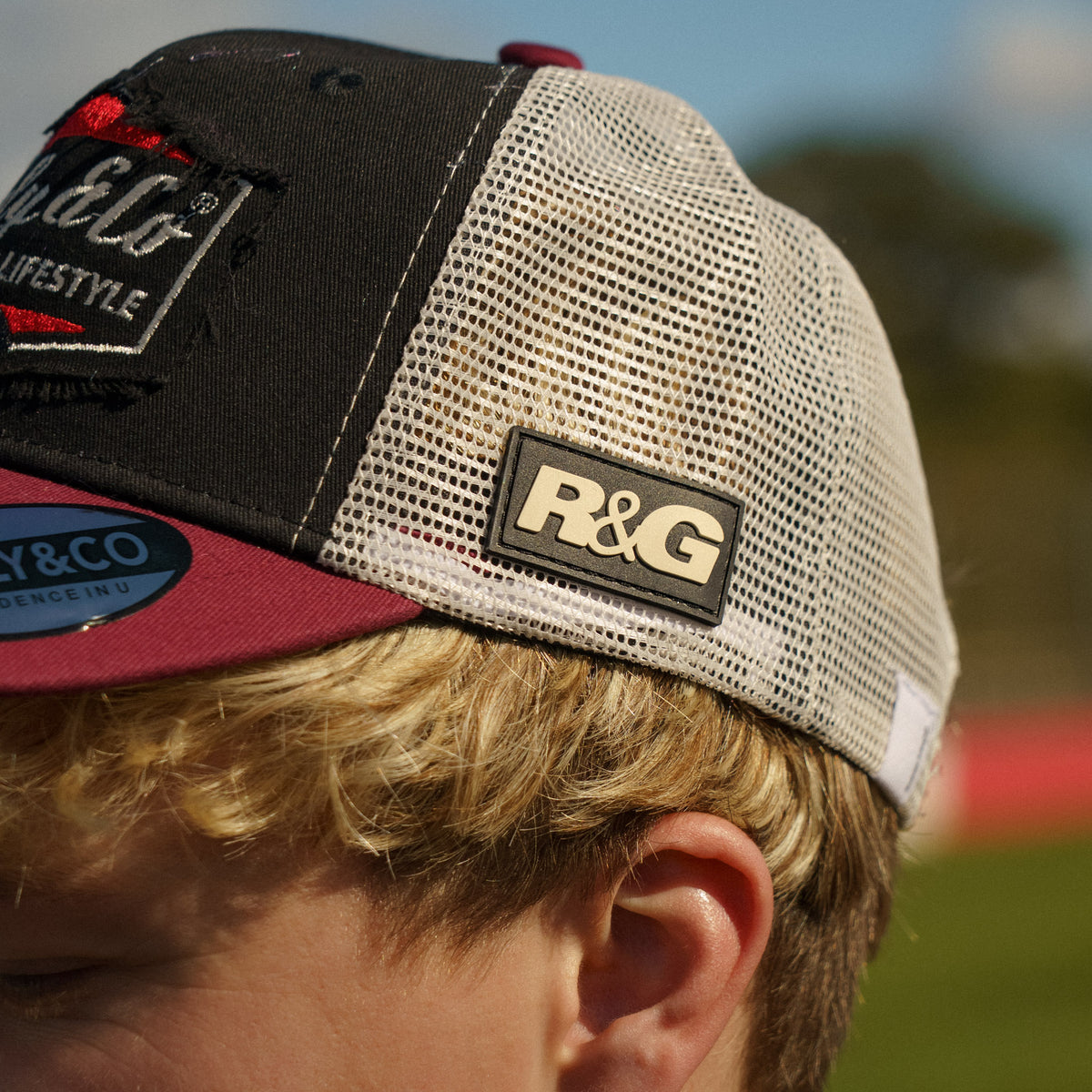 Close-up of the side logo on the R&G Crash Protection Trucker Cap