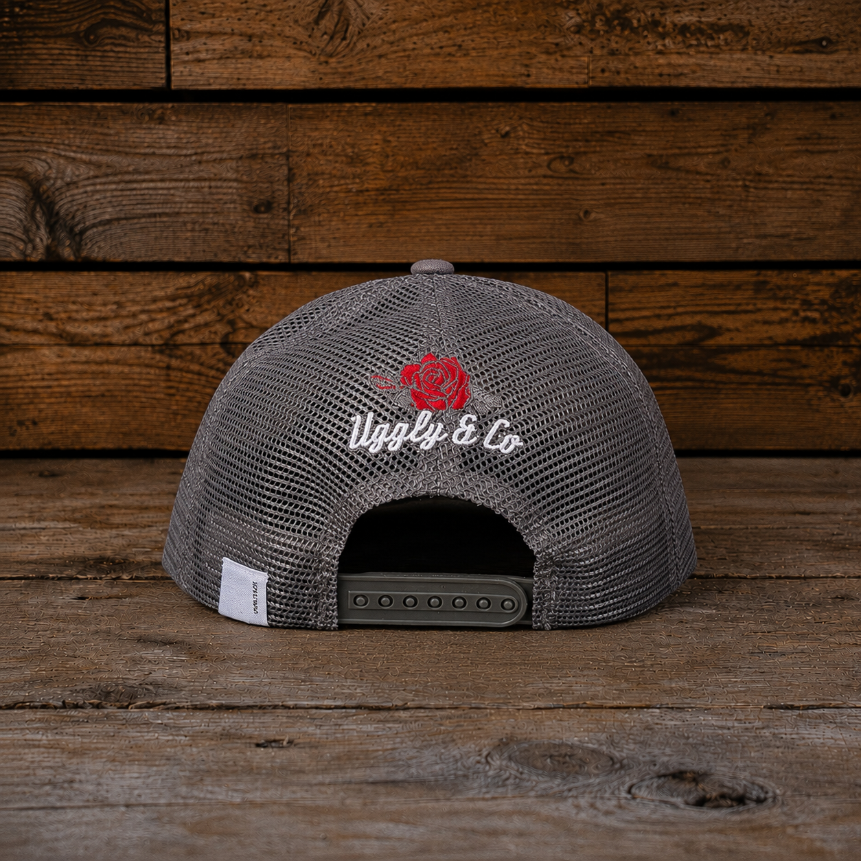 Back view of the Rose Diamond Cap showing the grey mesh panels, snapback closure, embroidered rose detail and small Uggly&Co rear tag.