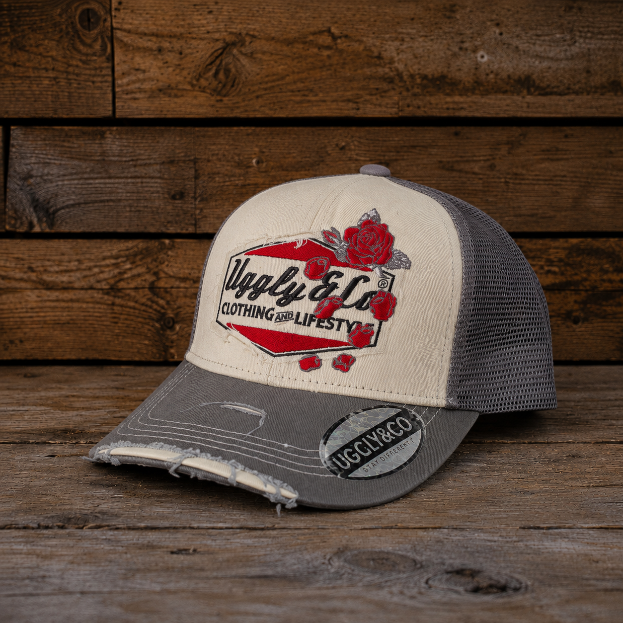 front view of the Rose Diamond Cap with Uggly&Co branding, red rose details, cream and grey panels, and a worn vintage-style curved peak. Trucker hat