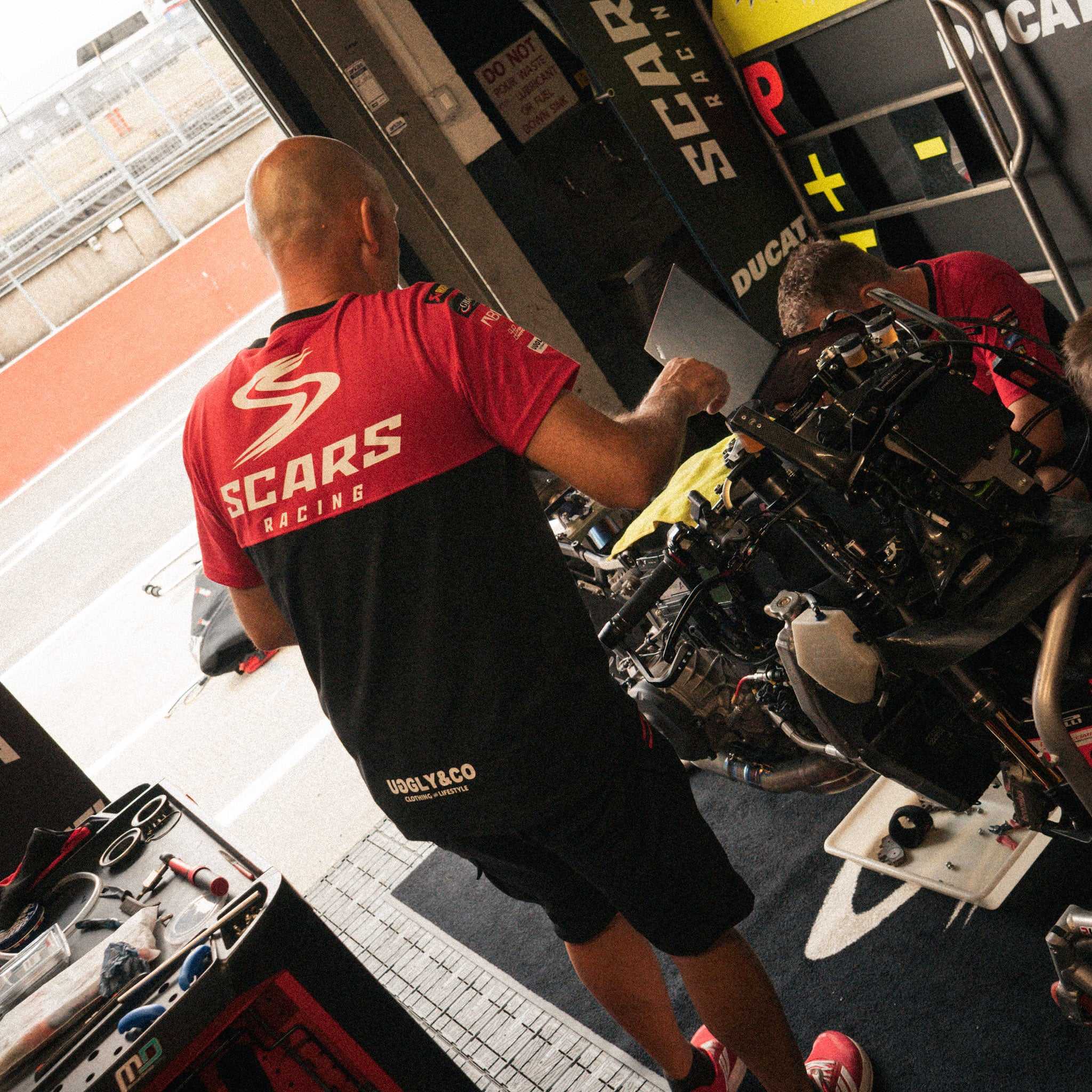 cars Racing motorsport T-shirt worn by mechanics in garage