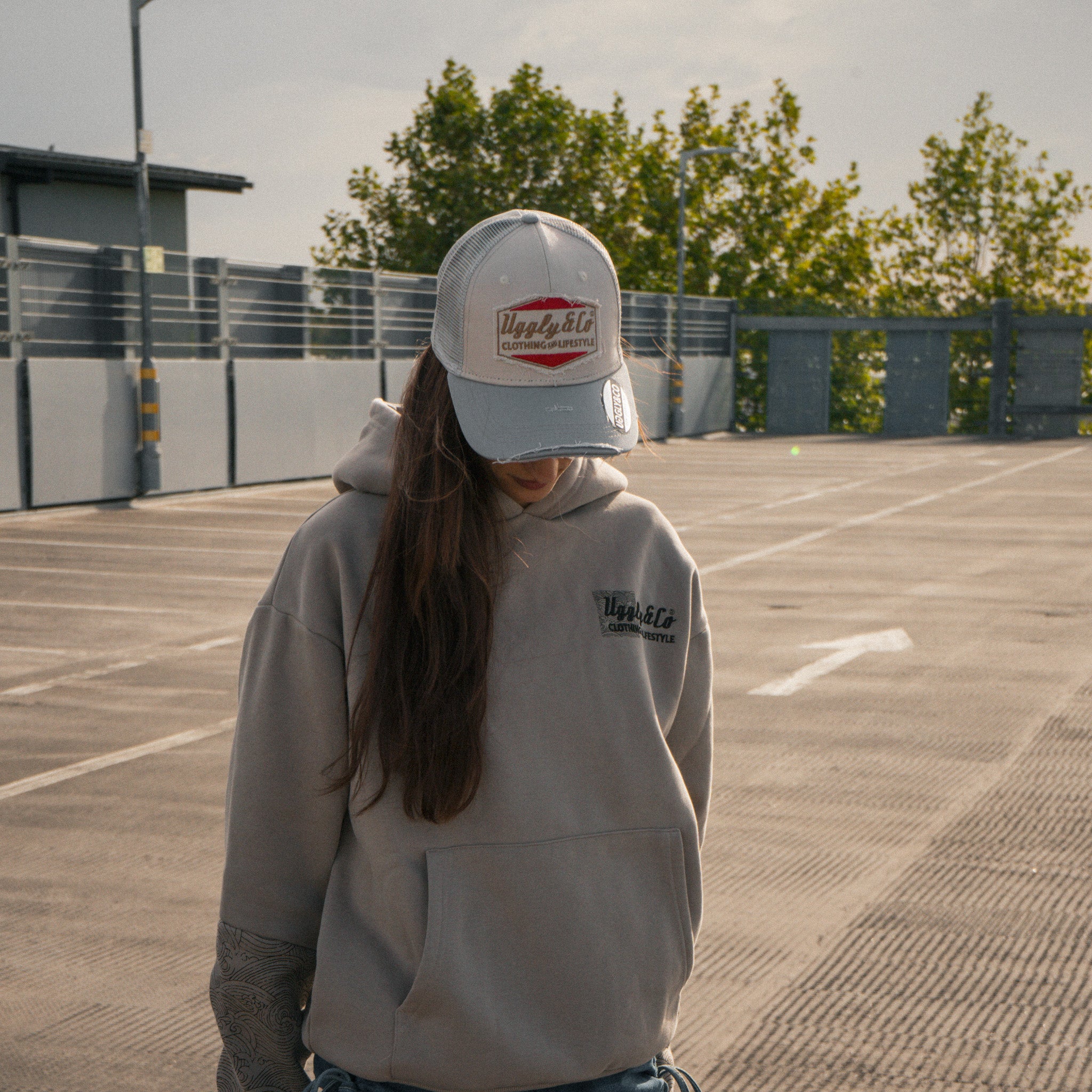 Female model wearing the Silver & Grey Diamond Trucker Hat