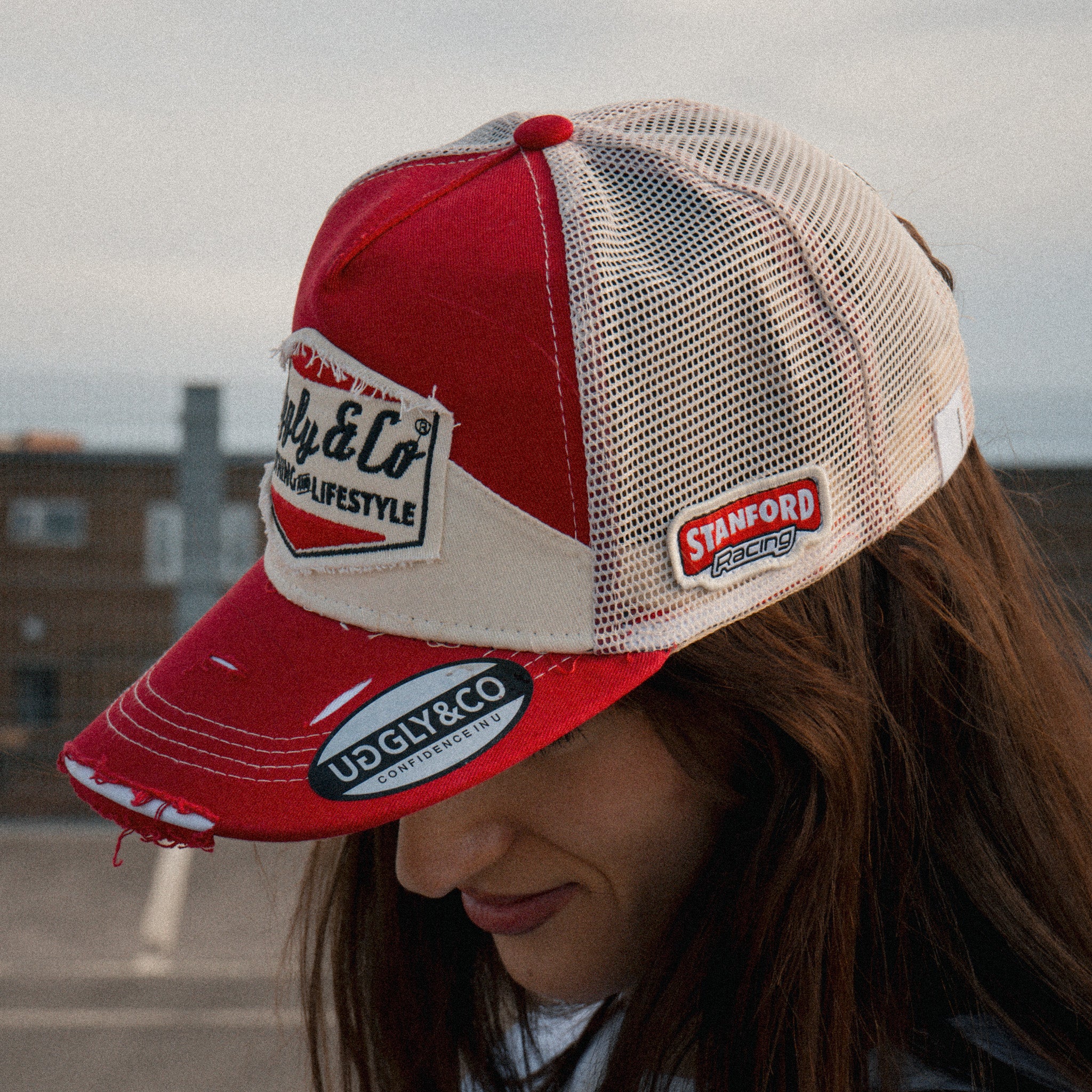 Lifestyle photo of a female model wearing the Smokin’ Diamond Trucker Hat. Marlboro inspired  cap.