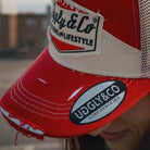 Close up detail of the Smokin’ Red Label Diamond Trucker Hat. Marlboro inspired cap