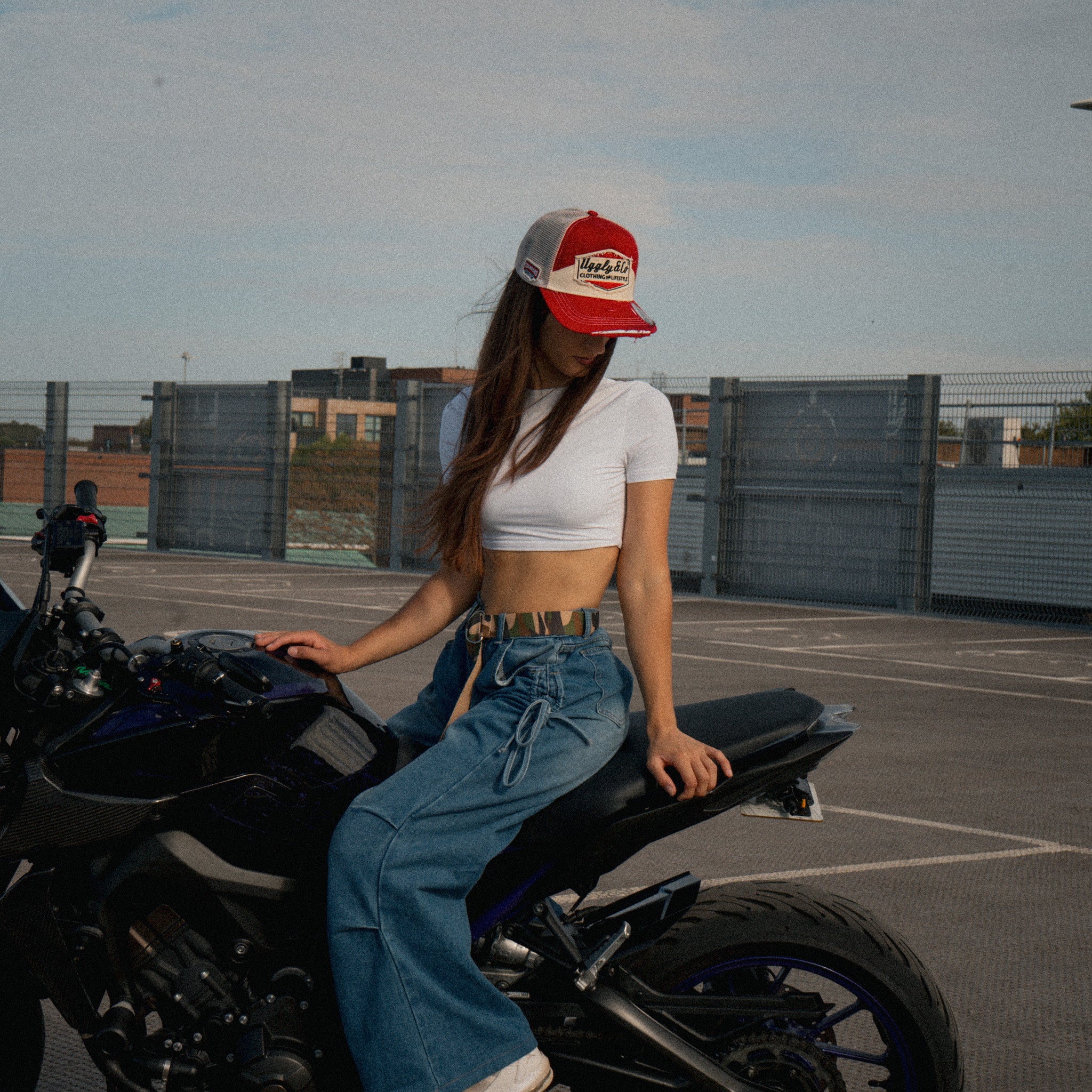 Female model styling the Smokin’ Red Label Diamond Marlboro inspired Trucker Hat