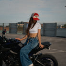 Female model styling the Smokin’ Red Label Diamond Marlboro inspired Trucker Hat