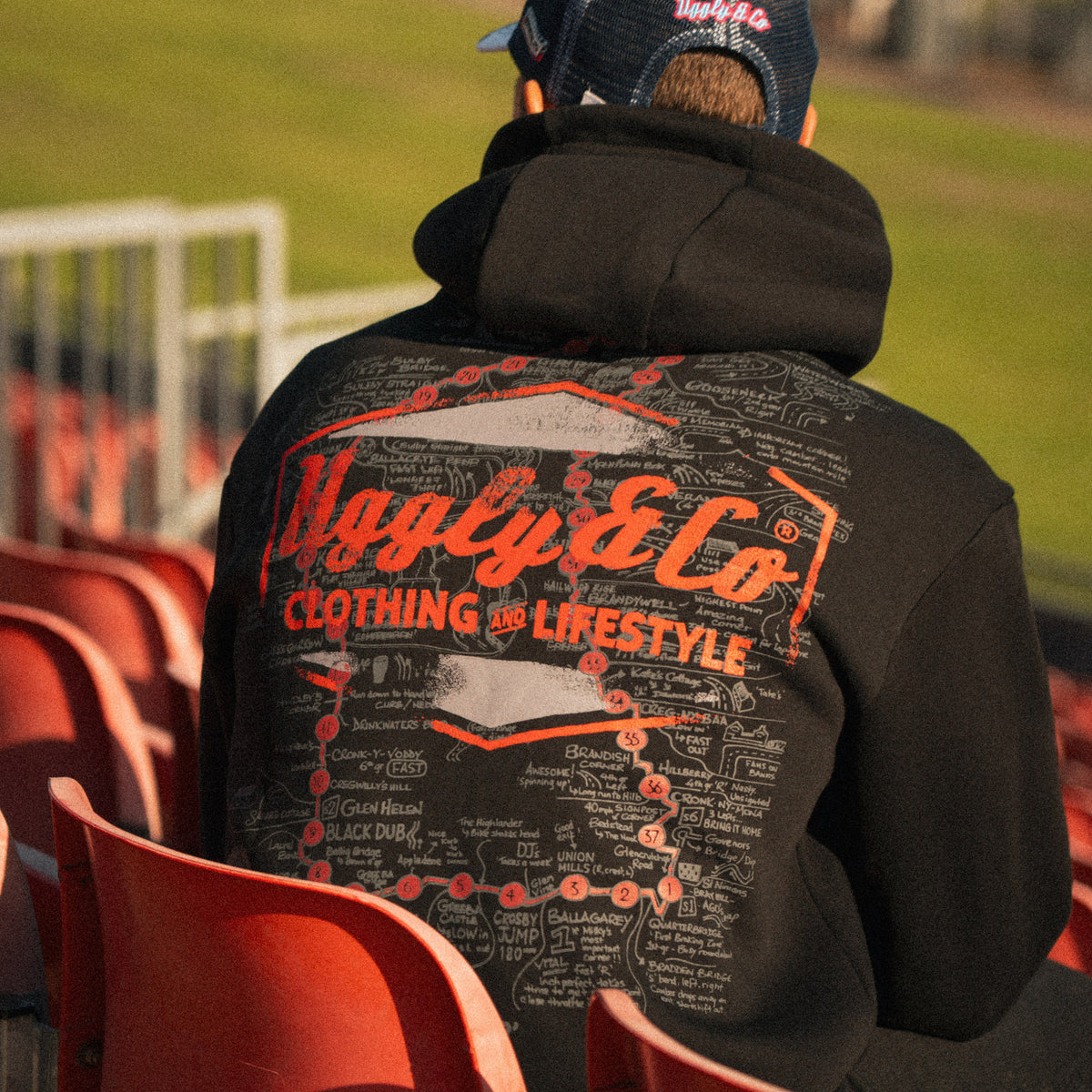 Josh Brookes wearing the Steve Day The Map black hoodie at Donington Park, showing the large Uggly & Co graphic on the back.