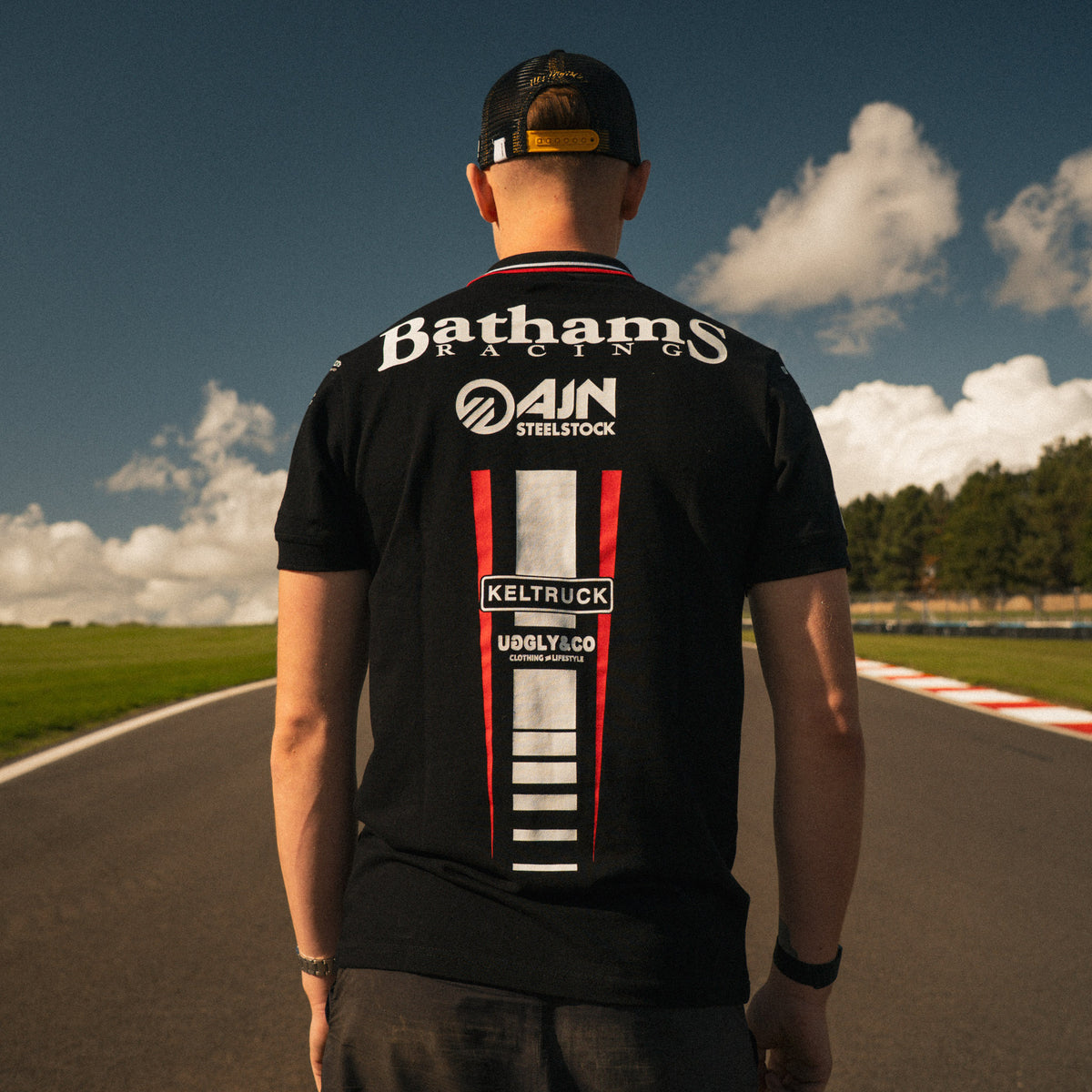 Back view of Storm Stacey wearing the Bathams Racing x AJN Steelstock Road Racing Polo at donington park circuit