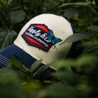 Close up of hat in forest with butterfly
