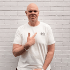 Front view of Tom Kerridge wearing a Butchers Tap and Grill white t-shirt with black graphics and text