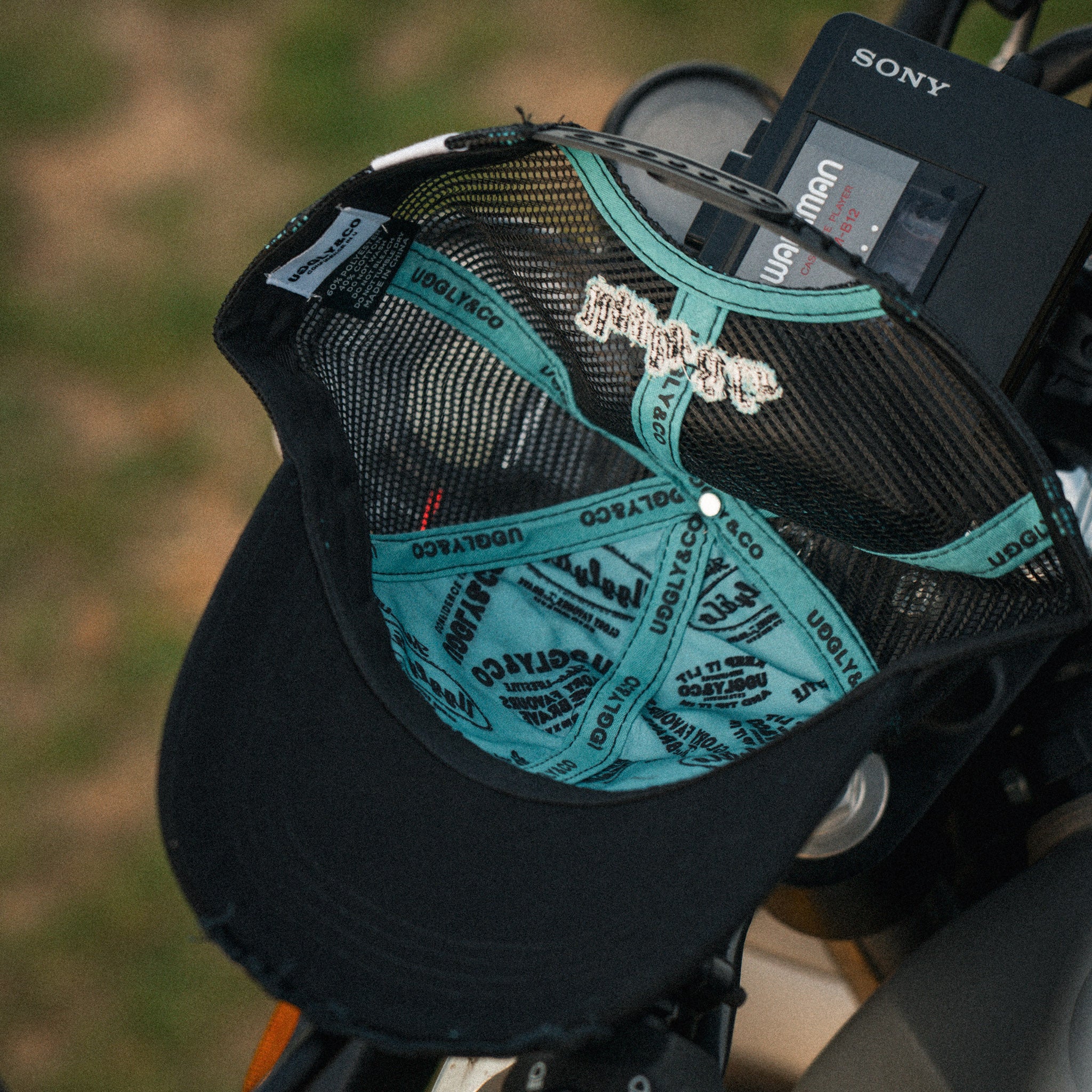 inner lining of black and turquoise trucker hat