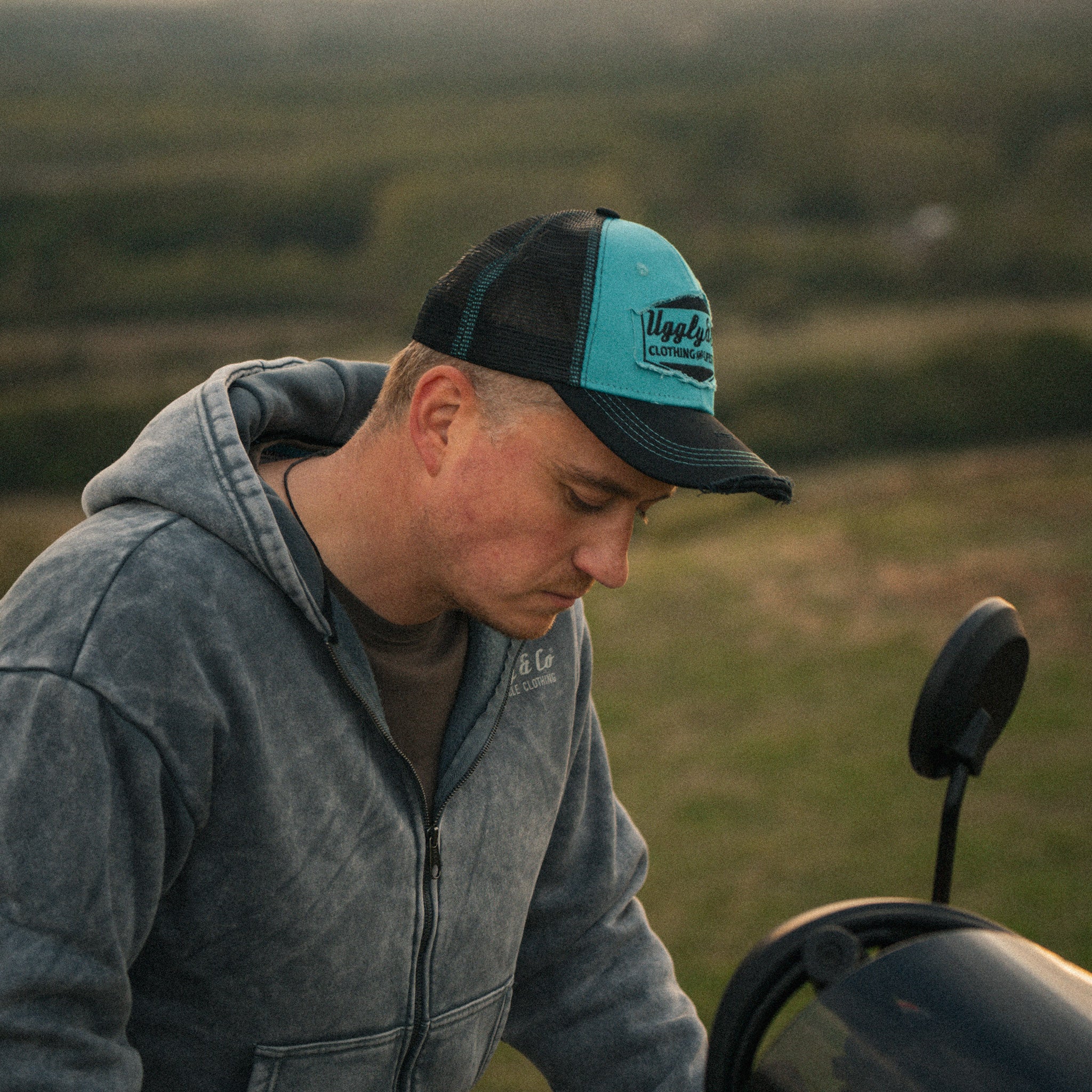 Turquoise & Black Diamond Cap worn in a lifestyle setting with a Scram 411