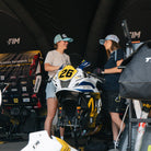 Katie hand with female mechanic wearing vintage trucker hat