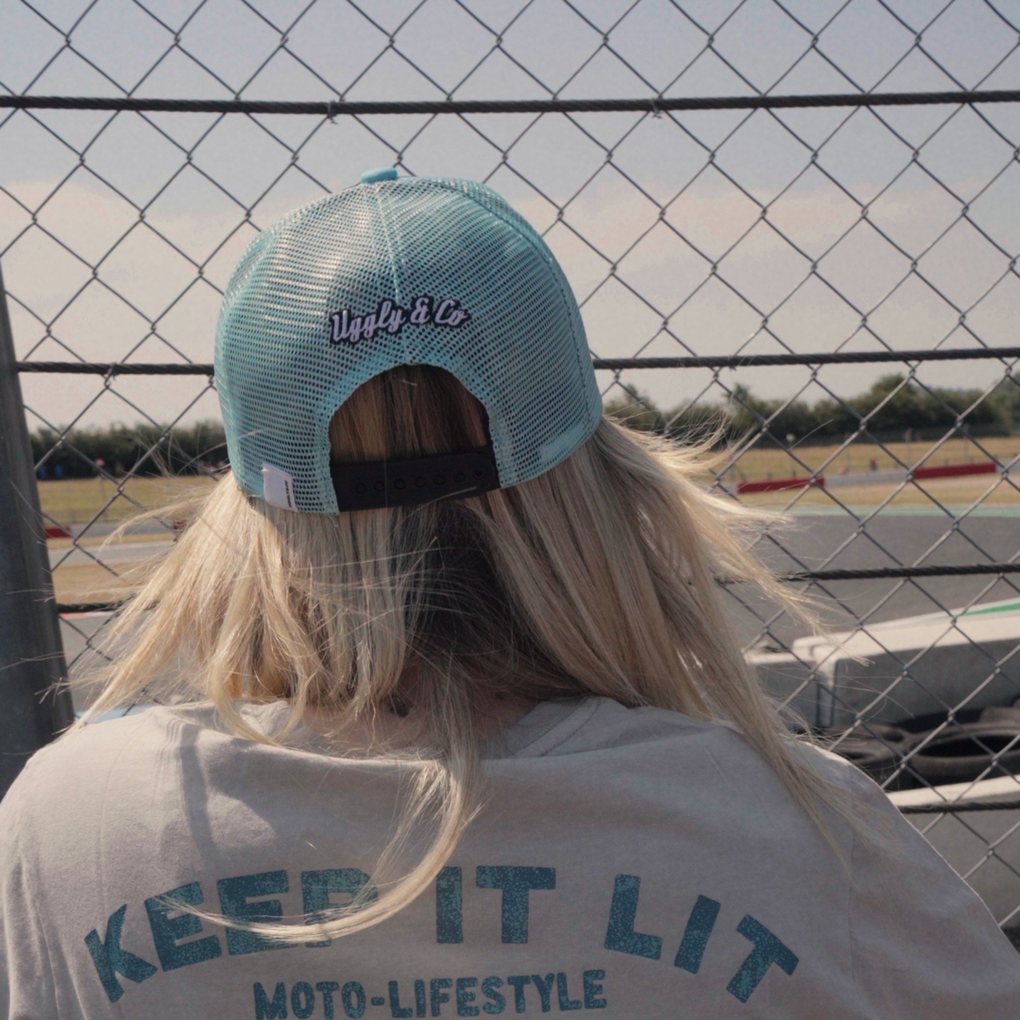 close up shot of Chloe jones wearing turquoise trucker hat