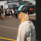 Chloe Jones wearing the Turquoise and Black Diamond Cap with a casual motorsport look